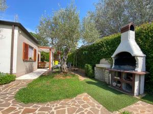 a backyard with a pizza oven in the yard at Timea A2 in Zambratija