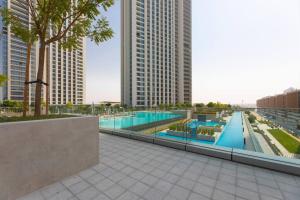 a swimming pool in a city with tall buildings at Sunny Downtown Retreat- Direct access to Dubai Mall in Dubai