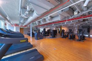 a gym with treadmills and elliptical machines at Sunny Downtown Retreat- Direct access to Dubai Mall in Dubai