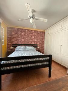 a bedroom with a bed with a ceiling fan at Abades Chalet in La Listada