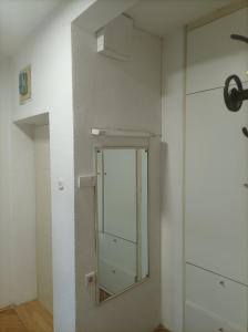 a mirror on a wall in a room at Стан in Prilep