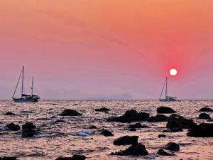 two boats in the ocean with a sunset at Room in Bungalow - Foresta Cottage of Koh Pu no6195 in Ko Jum