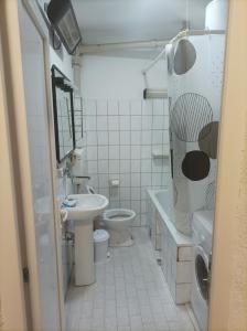 a bathroom with a sink and a toilet and a bath tub at Стан in Prilep