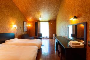 a hotel room with two beds and a mirror at Kussharoko Sauna Club in Teshikaga