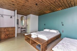 a bedroom with a bed and a wooden ceiling at Wakepond atostogų slėnis in Anykščiai