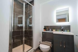 a bathroom with a shower and a toilet and a sink at Stunning Luxury Stay by VICHY in Hull