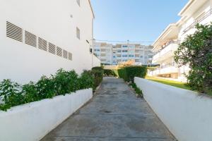 a walkway between two white buildings at Romantic: Precioso frente al mar in Sitges