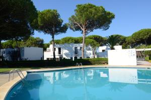 a swimming pool in front of a house with trees at PIVERD DEL GOLF 75 in Pals