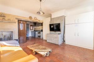 a living room with a couch and a table and a tv at Authentique Appartement Aixois in Aix-en-Provence +3 photos