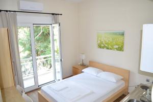 a bedroom with a bed and a large window at Hotel Europa - Family and Senior Friendly in Kavala