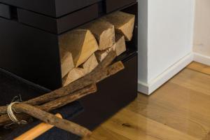 a pile of wood in a box with a rope at Design Ferienwohnung Königssee in Schönau am Königssee