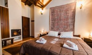 a bedroom with a large bed with two towels at Guesthouse Armakas in Kalavrita