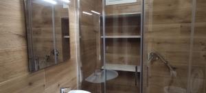 a shower with a glass door in a bathroom at Dimora Gassi White in Mola di Bari