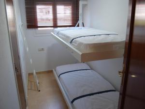 Ce dortoir comprend 2 lits superposés et une fenêtre. dans l'établissement Apartamento Llançà, 2 dormitorios, 6 personas - ES-228-36, à Llançà