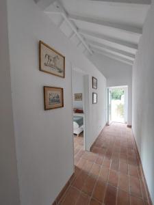 a hallway with white walls and a tile floor at Azenha da Duquesa in Sintra