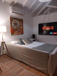 a bedroom with a bed with a television on the wall at Azenha da Duquesa in Sintra