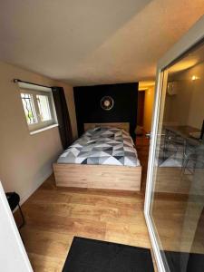 a small bedroom with a bed and a window at studio avec jardin et stationnements in Bourges