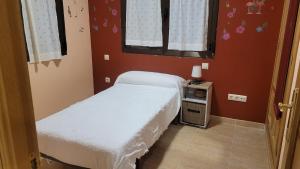 a small bedroom with two beds and a window at Alma de Gredos in Ávila