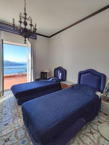a bedroom with two beds and a view of the ocean at Giardino 21 Marzo in Vico Equense