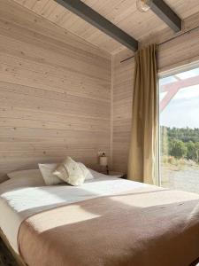 a bedroom with a large bed with a window at Finca Les Coves in Jijona