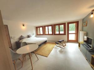 a bedroom with a bed and a table and a tv at Villa Bagno Santo in Sarteano