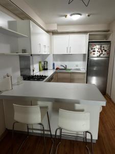 a kitchen with white cabinets and a white counter top at Atasehir Rezidans in Istanbul