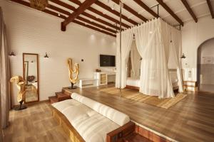a large room with a bed and a bedroom at Lov Faralya Adults Only in Faralya