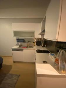a kitchen with white cabinets and a sink at Atasehir rezidans in Istanbul