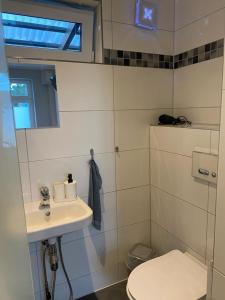 a bathroom with a sink and a toilet at Apartment 1 in Neuruppin