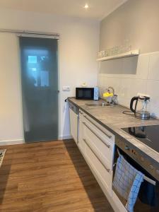 a kitchen with a sink and a stove top oven at Apartment 1 in Neuruppin