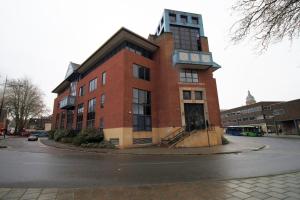 a red brick building on the corner of a street at Central Charming and Contemporary 2Br Apartment in Swindon