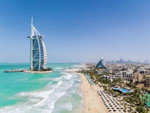 a view of the beach and the burj khalifa at Peaceful escape near the beach with private garden in Dubai