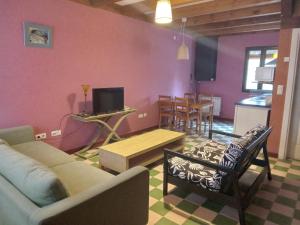 a living room with a couch and a table at Villabamba in Valdeavellano de Tera