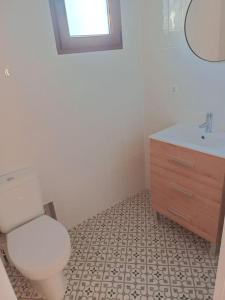 a bathroom with a toilet and a sink at Hogar con encanto en Segorbe in Segorbe