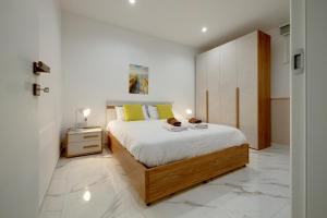 a bedroom with a bed and a night stand at Sliema 2BR Great Location with Terrace in Sliema +48 photos