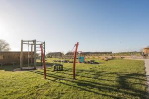 an empty park with a playground with swings at Ferienhof Büdlfarm - Nord Ost in Sahrensdorf