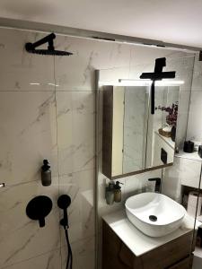 a white bathroom with a sink and a shower at Premium Apartment 90m2 in Thessaloniki +12 photos