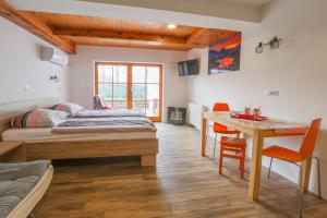 a bedroom with a bed and a desk and a table at Jazz Bled Guest House in Bled