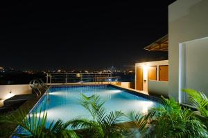 a swimming pool on the roof of a building at night at Infinia Stays - A Luxury Boutique Hotel in Udaipur