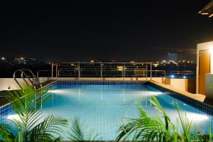 - une piscine au-dessus d'un bâtiment la nuit dans l'établissement Infinia Stays - A Luxury Boutique Hotel, à Udaipur