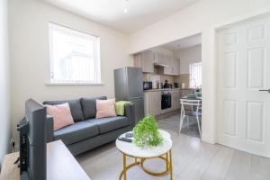 a living room with a couch and a table at Free Parking | Free Wifi | Stylish in Newport