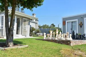 a yard with a giant chessboard in front of a house at Villa Palesa Guesthouse in Grahamstown