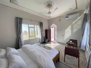 a bedroom with a large bed and a window at Jabal Shams, the summit house in Misfāh