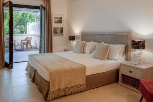 a bedroom with a large bed and a balcony at Canne Bianche Lifestyle Hotel in Torre Canne