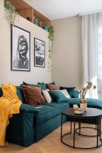 a living room with a blue couch and a table at NEW! High-street stylish flat (NDK) FREE Parking in Sofia