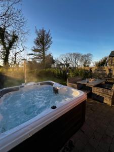 a jacuzzi tub sitting on a patio at The Farmhouse at Corrstown Village in Portrush