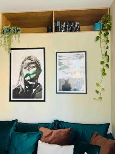 a living room with a couch and two pictures on the wall at NEW! High-street stylish flat (NDK) FREE Parking in Sofia