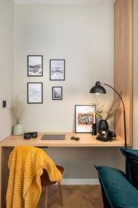 a desk with a laptop and pictures on the wall at NEW! High-street stylish flat (NDK) FREE Parking in Sofia