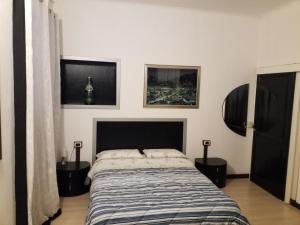 a bedroom with a bed and two night stands at Casa Nunzia in Domodossola