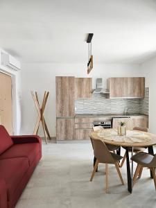 a living room with a red couch and a table at Il Nido in Marina di Montenero